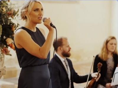 Singing their wedding song with a string quartet in their performance