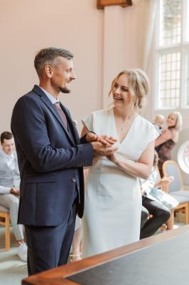 Bride and groom smiling during their vows at Cheshunt Register Office